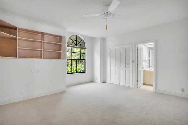 unfurnished bedroom with connected bathroom, ceiling fan, light carpet, and a closet