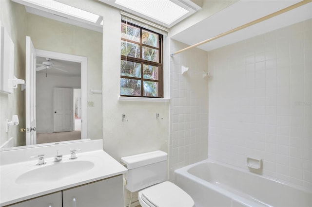 full bathroom featuring toilet, tiled shower / bath combo, and vanity