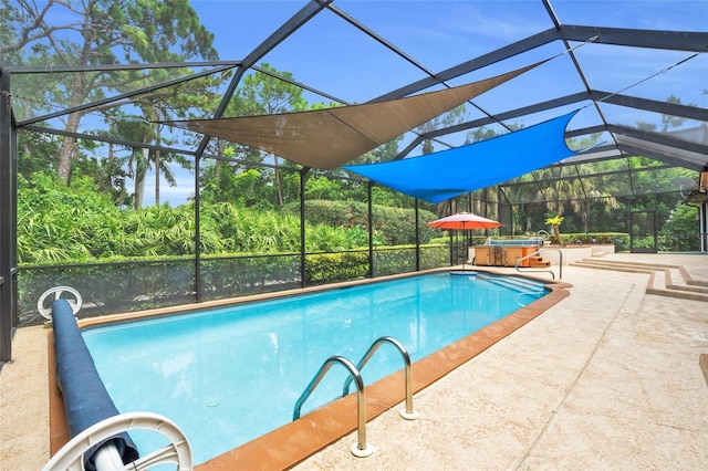 view of pool with a patio, a hot tub, and a lanai