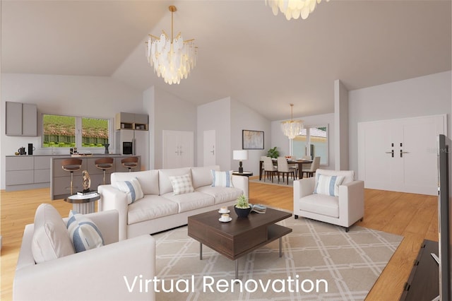 living room featuring a wealth of natural light, a notable chandelier, and light hardwood / wood-style floors