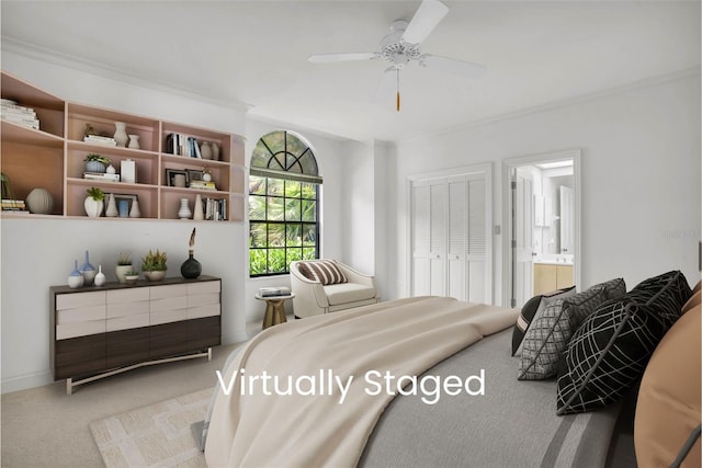 carpeted bedroom with a closet, ornamental molding, ensuite bathroom, and ceiling fan