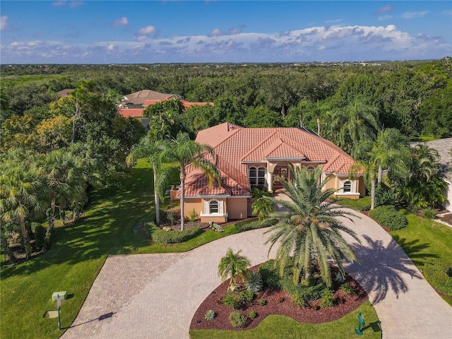 birds eye view of property with a wooded view