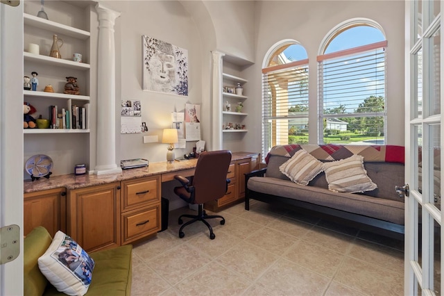 home office with light tile patterned floors, built in study area, and built in features