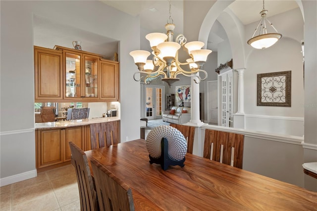 dining space featuring a notable chandelier and light tile patterned floors