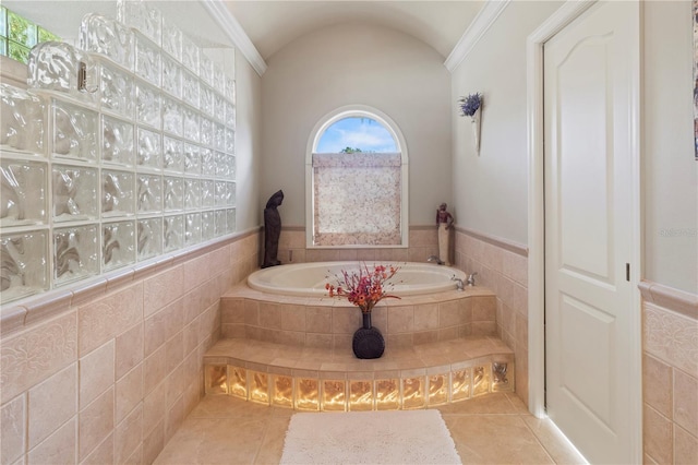 bathroom with wainscoting, a garden tub, tile walls, and tile patterned floors