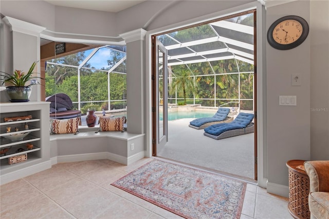 interior space with a sunroom, baseboards, and light tile patterned floors