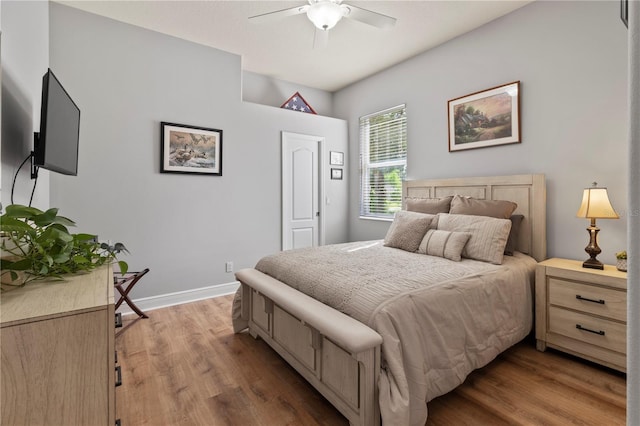 bedroom with ceiling fan, light wood-type flooring, and baseboards