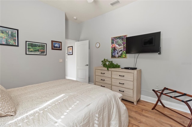 bedroom with light wood-type flooring, visible vents, and baseboards