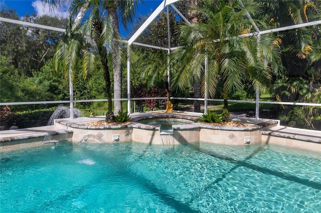 outdoor pool featuring a lanai and an in ground hot tub