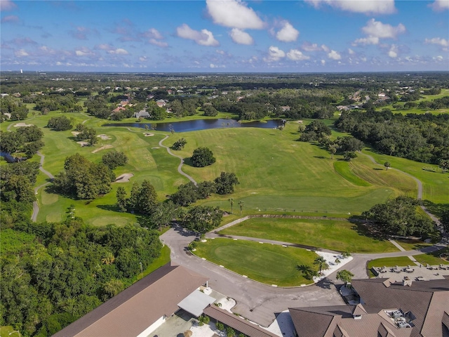 drone / aerial view with golf course view and a water view