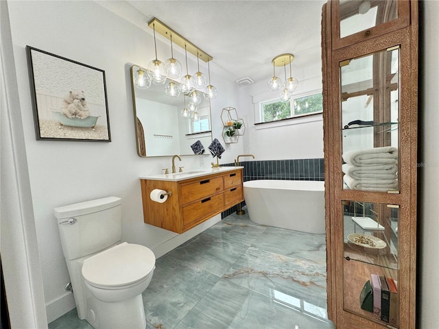 bathroom featuring vanity, a bath, toilet, and tile patterned floors