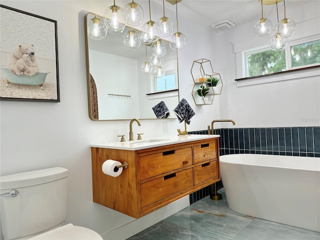 bathroom featuring a tub, tile patterned flooring, toilet, and vanity