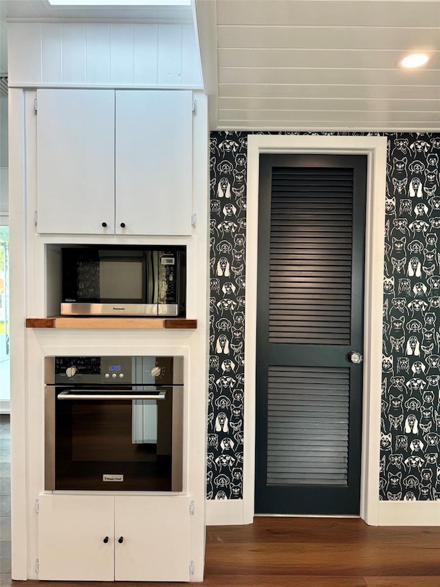 kitchen with dark wood-type flooring and stainless steel appliances