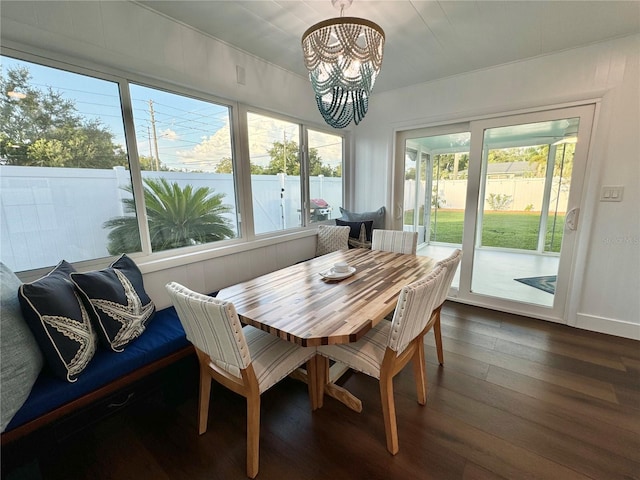 dining room with plenty of natural light, dark hardwood / wood-style floors, and a chandelier