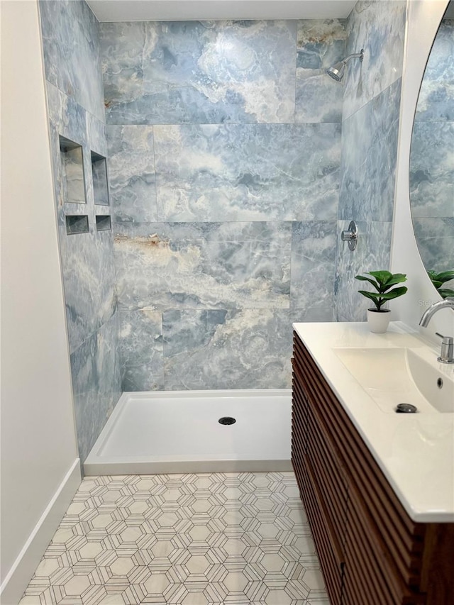 bathroom with vanity and a tile shower