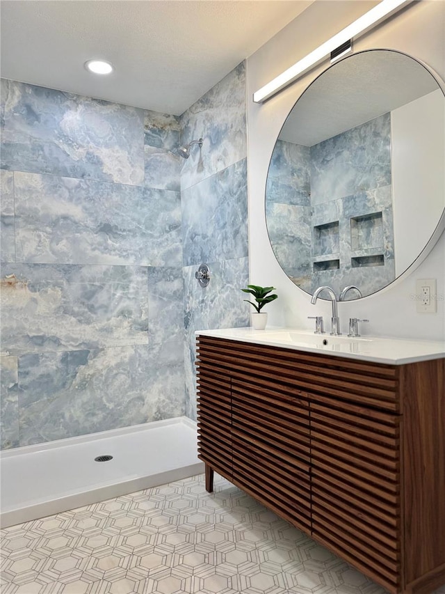 bathroom featuring vanity and a tile shower