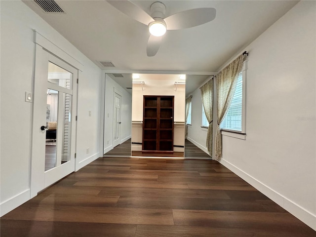 empty room featuring ceiling fan and dark hardwood / wood-style floors