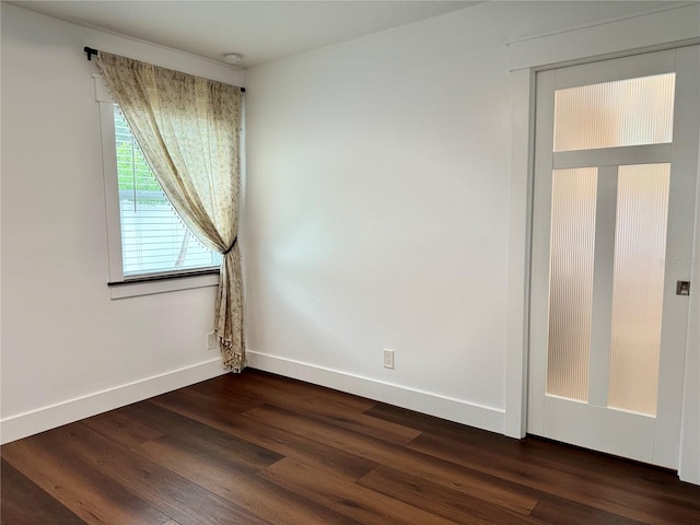 spare room with dark wood-type flooring