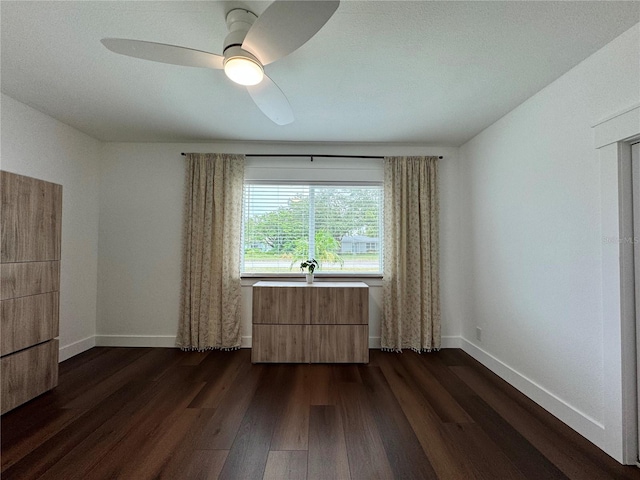 unfurnished room featuring ceiling fan and dark hardwood / wood-style flooring