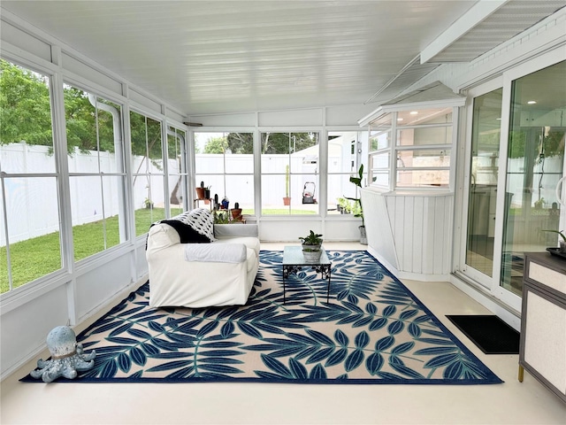 sunroom featuring a healthy amount of sunlight and vaulted ceiling