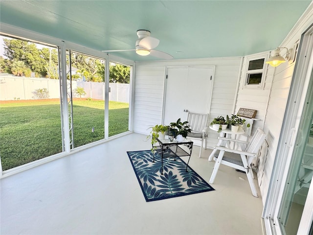 sunroom / solarium featuring ceiling fan