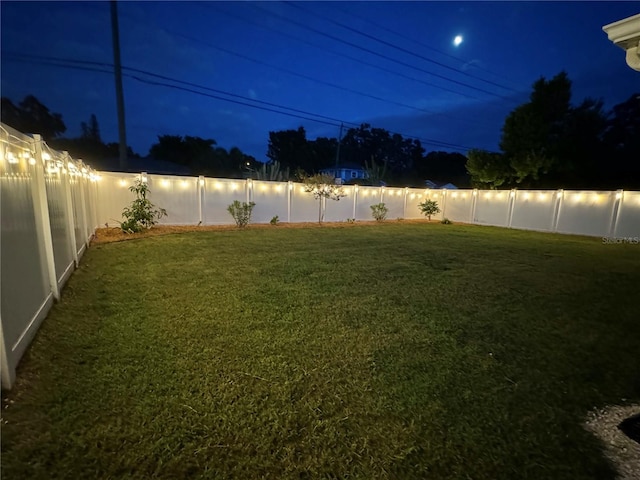 view of yard at twilight