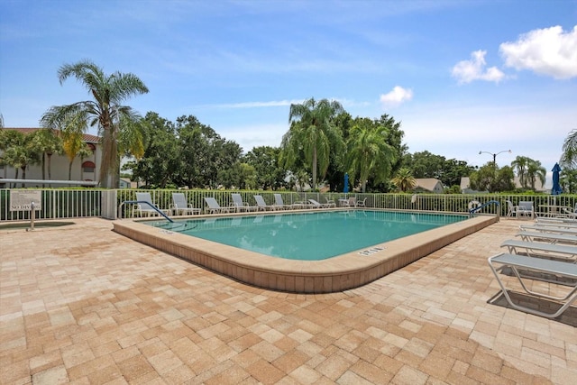 pool featuring a patio and fence