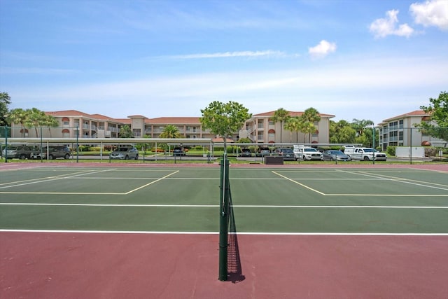 view of tennis court featuring fence