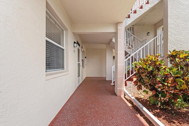 entrance to property featuring stucco siding