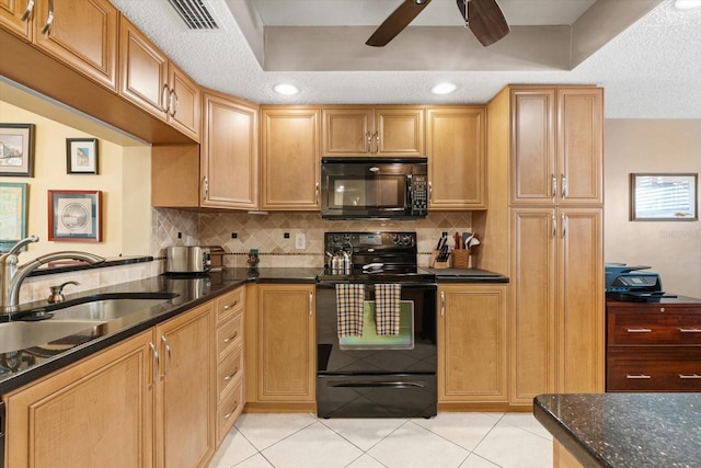 kitchen with dark stone counters, black appliances, sink, a textured ceiling, and light tile patterned flooring