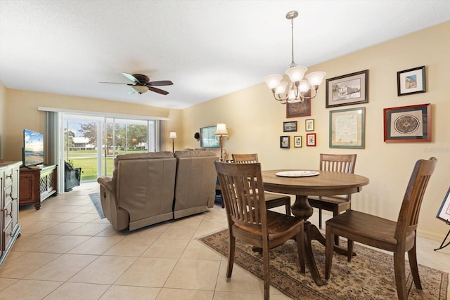 dining area featuring light tile patterned flooring and ceiling fan with notable chandelier