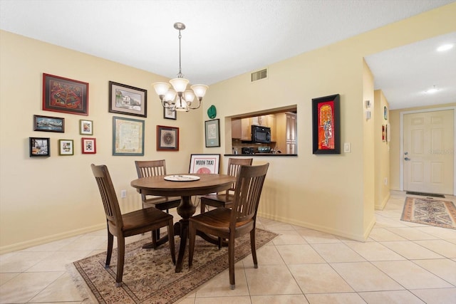 dining room with baseboards, visible vents, an inviting chandelier, and light tile patterned flooring