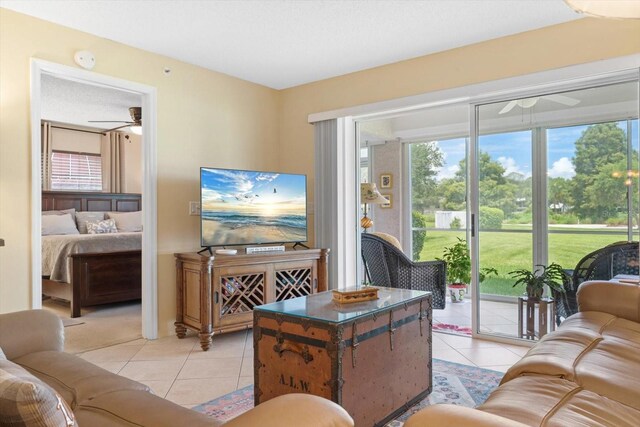 living room with ceiling fan and light tile patterned floors