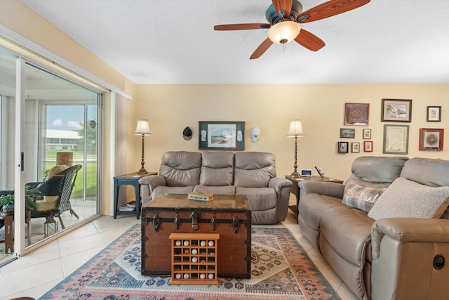 living room featuring light tile patterned floors, a textured ceiling, and a ceiling fan