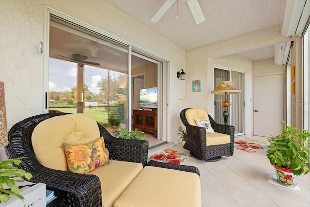 sunroom / solarium featuring ceiling fan