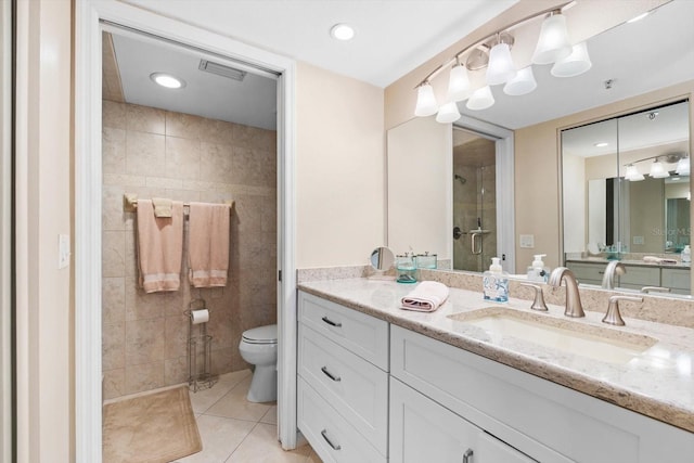 bathroom with tile patterned flooring, toilet, visible vents, vanity, and a stall shower