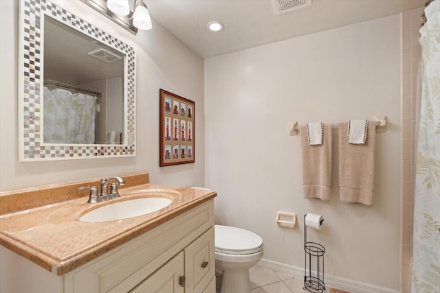 bathroom featuring tile patterned flooring, toilet, vanity, visible vents, and baseboards