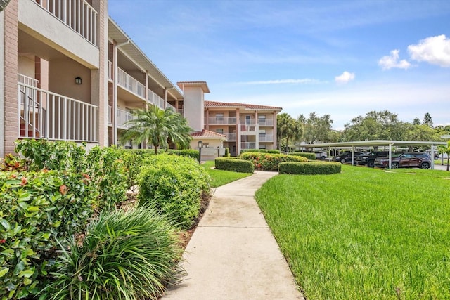 view of property's community with a lawn