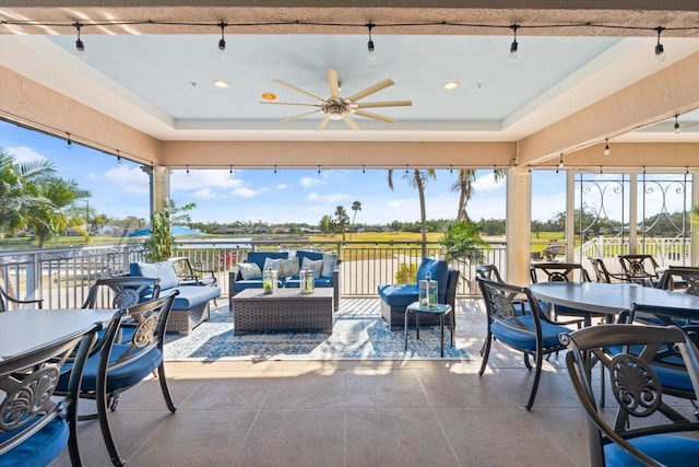 interior space with ceiling fan and a tray ceiling