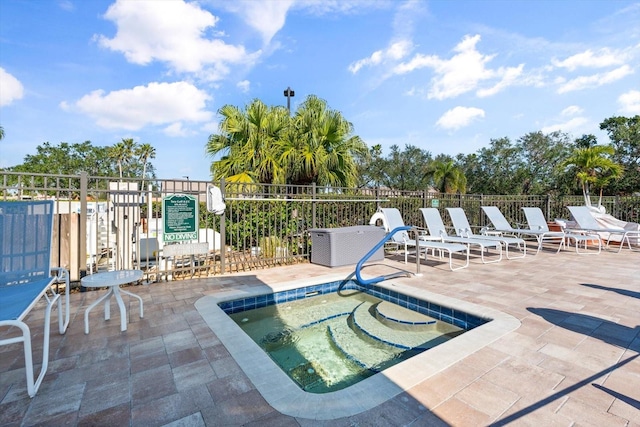 view of swimming pool with a patio and a hot tub