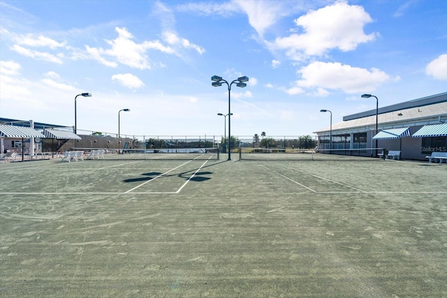 view of sport court featuring fence