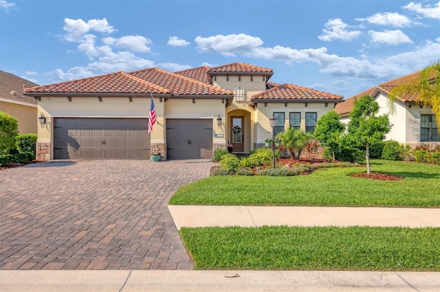 mediterranean / spanish-style house with a front yard and a garage