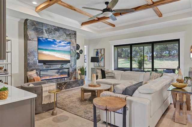 living room featuring ceiling fan, ornamental molding, and a fireplace