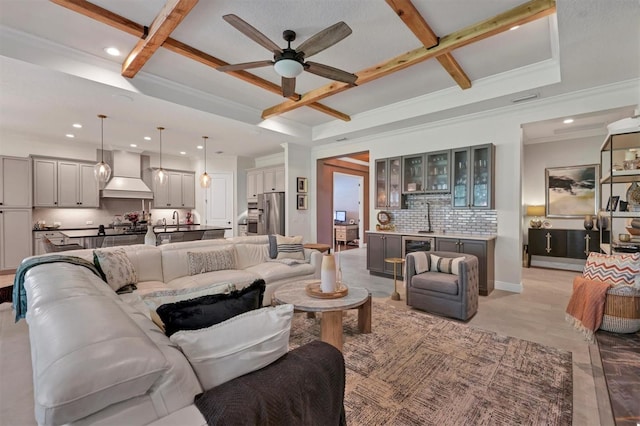 living room featuring coffered ceiling, ceiling fan, beam ceiling, and wet bar