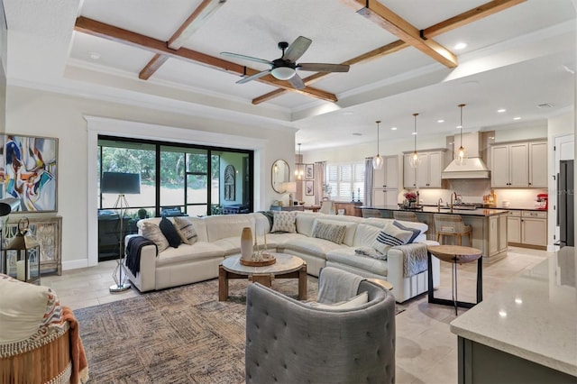 living room featuring beam ceiling, ornamental molding, ceiling fan, coffered ceiling, and baseboards