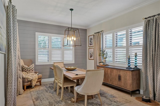 tiled dining area with crown molding, wooden walls, and a chandelier