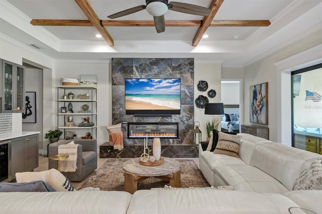 living area with visible vents, coffered ceiling, a premium fireplace, ornamental molding, and a bar