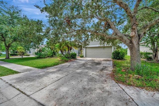 obstructed view of property featuring a garage and a front yard