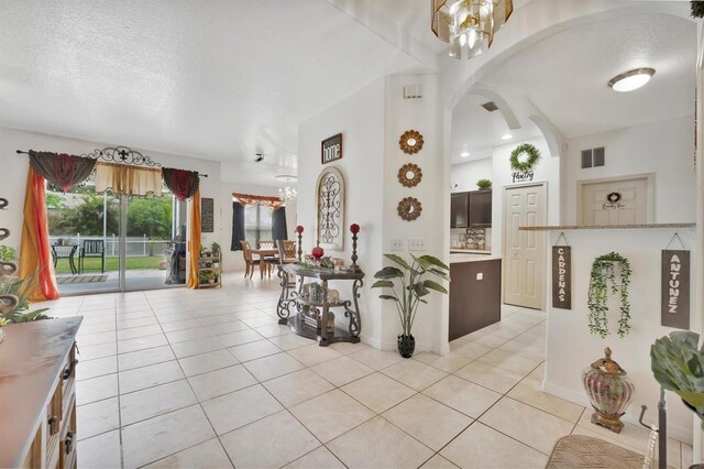 interior space featuring a textured ceiling and an inviting chandelier