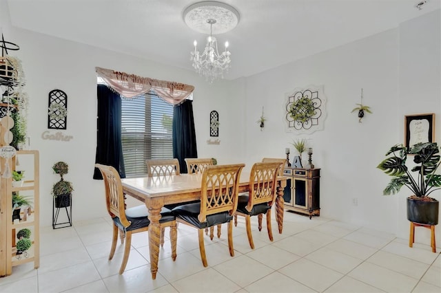 tiled dining room featuring a chandelier